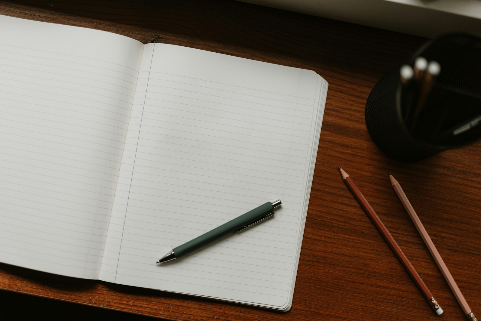 An open blank notebook with a pen, ready for a first set of notes